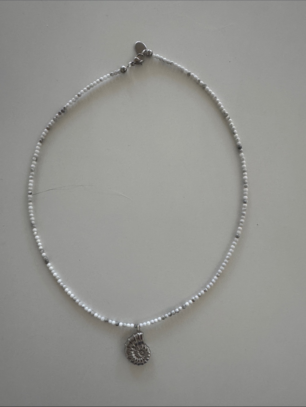 White Beaded Necklace with Silver Shell Pendant